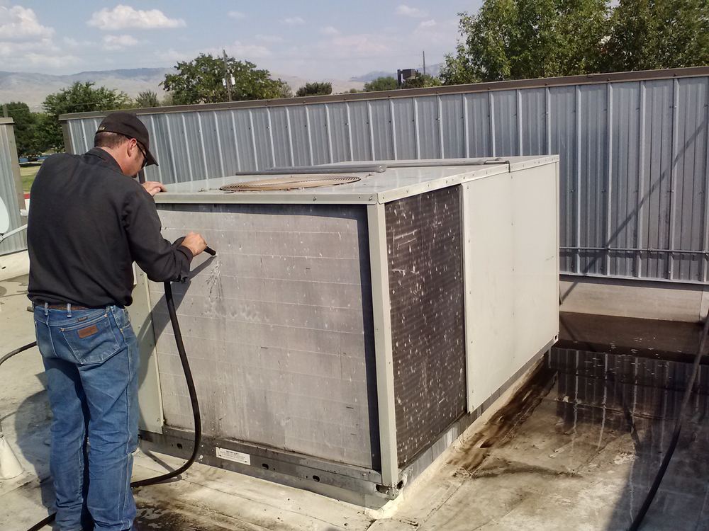 Washing down a rooftop AC unit